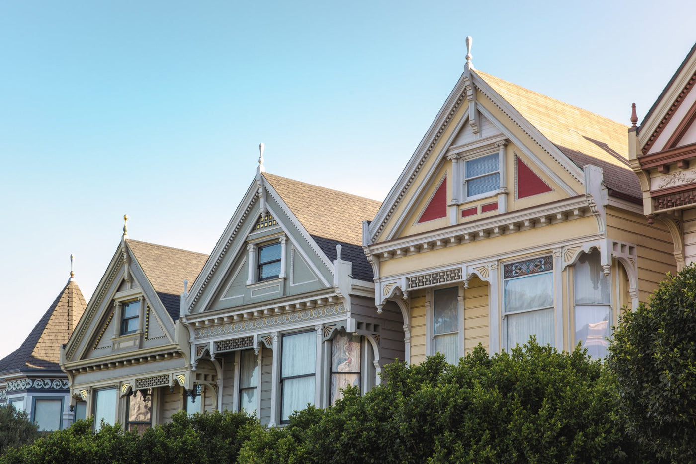 This image features Victorian-style houses, likely the "Painted Ladies" of San Francisco, known for their ornate details and vibrant colors. 